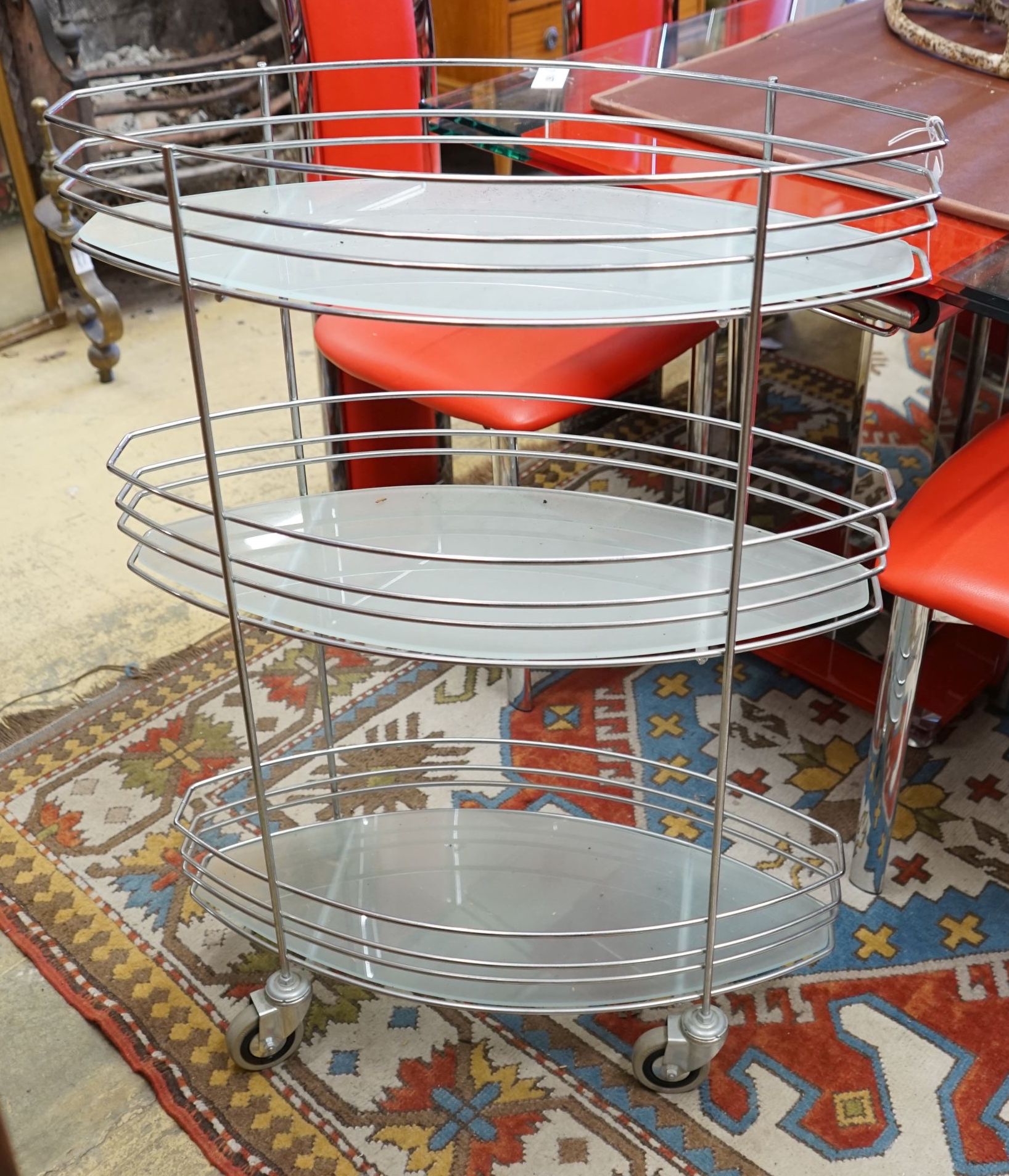 A three tier chrome and glass service trolley, width 65cm depth 27cm height 93cm